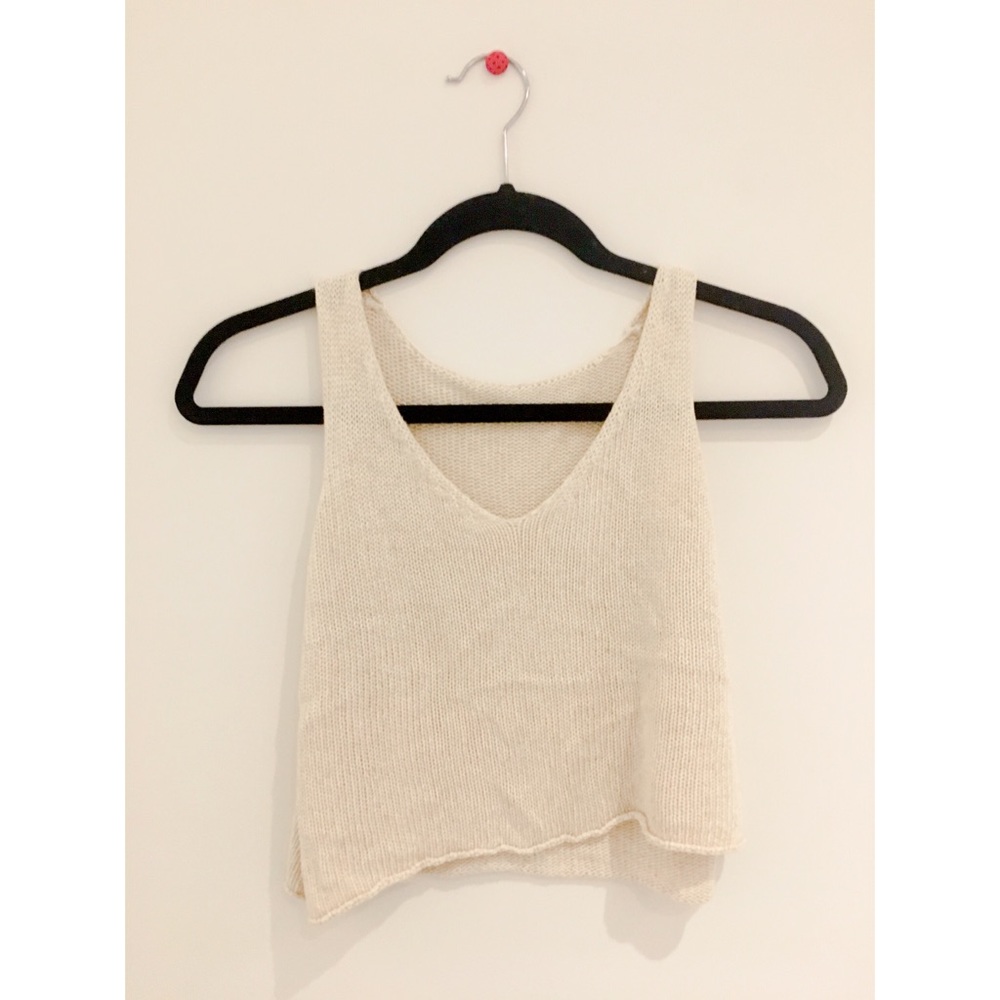 A beige, knit, cropped tank